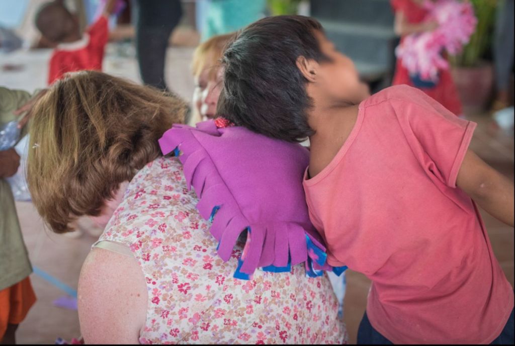 child resting on woman's back with pillow